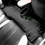 Black textured TPE car floor mats with vibrant green edge stitching for BYD interior protection.