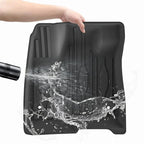Waterproof black TPE car floor mat with raised edges for spill protection.