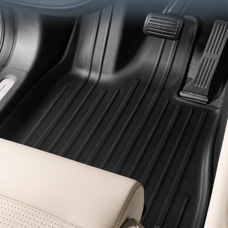 Black heavy-duty TPE custom-fit floor mats with anti-slip ribbed texture for car protection.
