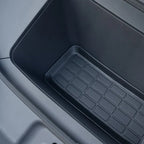 Black textured rubber center console storage tray for BYD car interior.