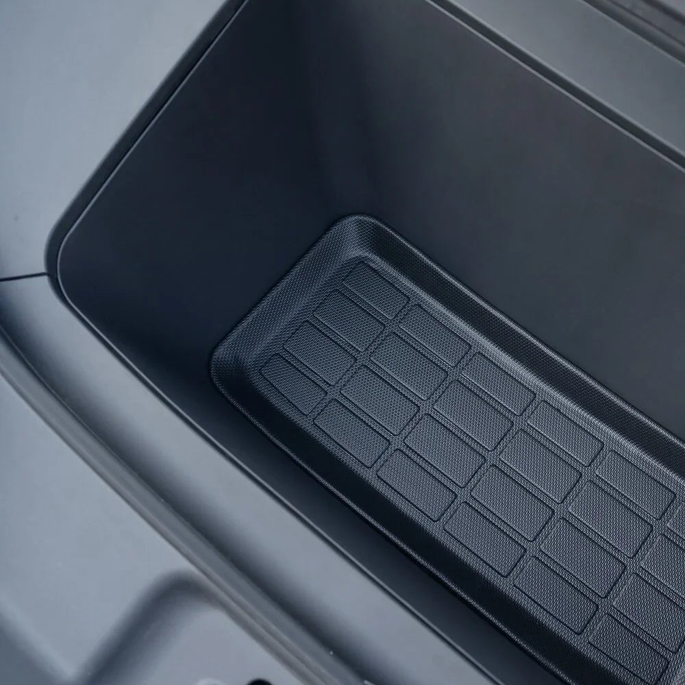 Black textured rubber center console storage tray for BYD car interior.