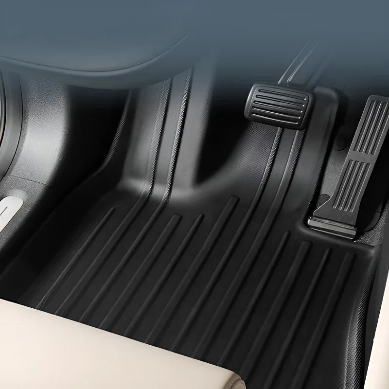 Professional black TPE custom-fit car floor mats with ribbed anti-slip texture.
