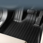 Professional black TPE custom-fit car floor mats with ribbed anti-slip texture.