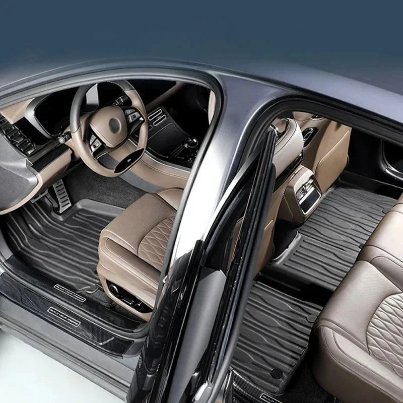 Custom-fit black TPE car floor mats for BYD interior with durable anti-slip texture.