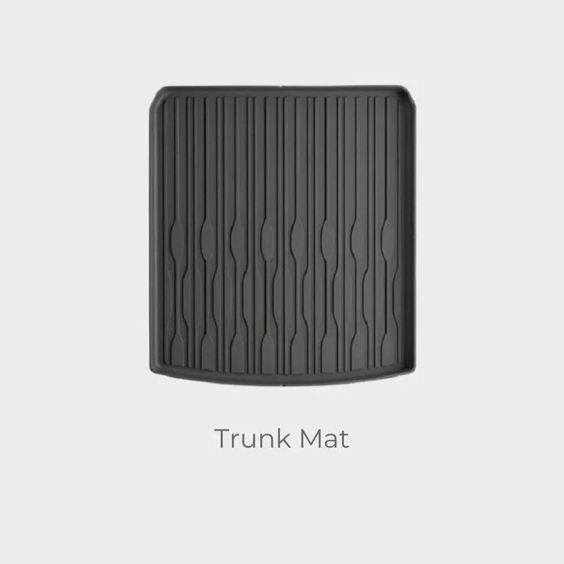 Durable black rubberized trunk mat with a textured anti-slip ribbed design for car protection.