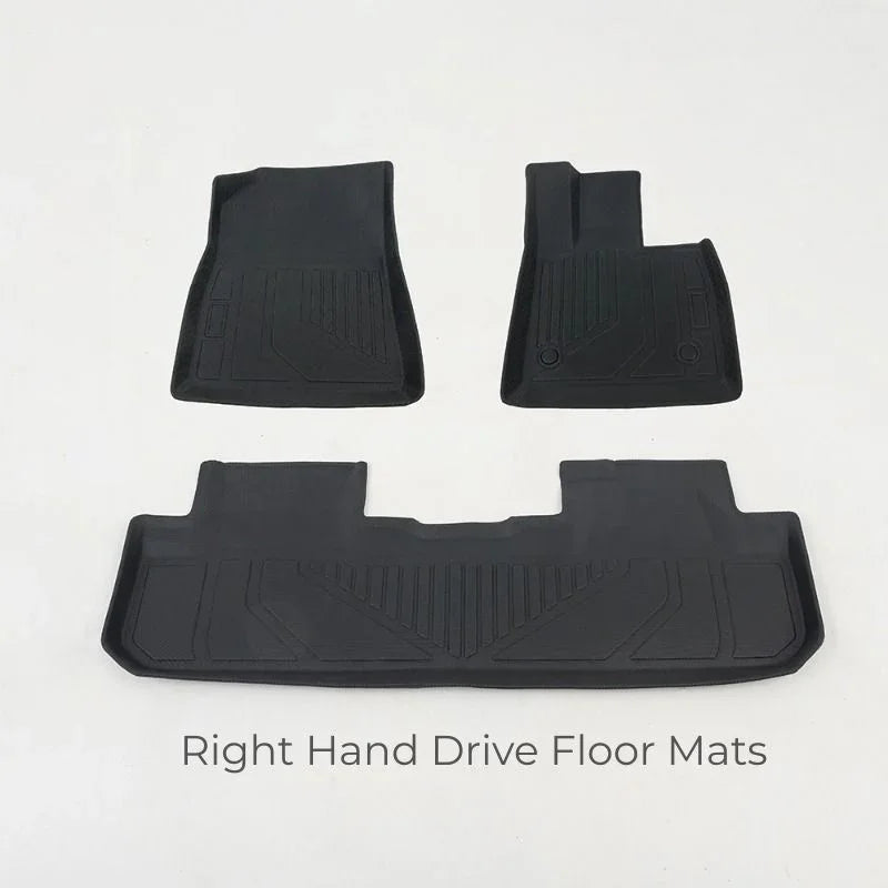 Set of black heavy-duty rubber right hand drive floor mats with textured grip patterns.