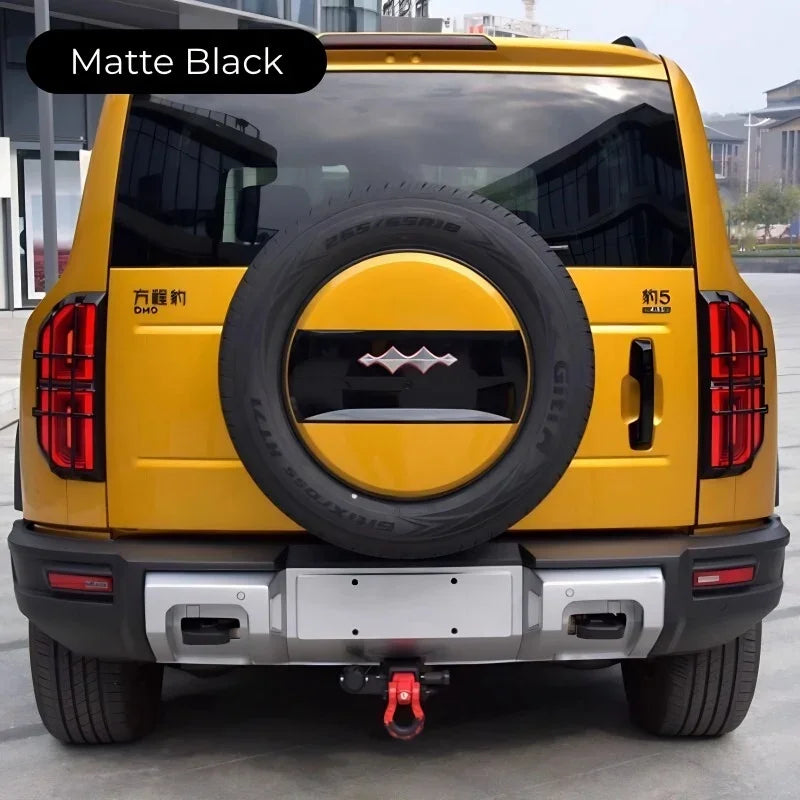 Matte black spare tire cover on a yellow BYD SUV rear mounted spare wheel.