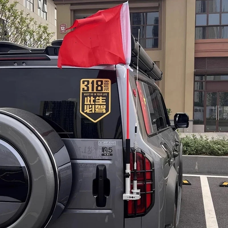 Red and white outdoor flag accessory mounted on a grey SUV's rear