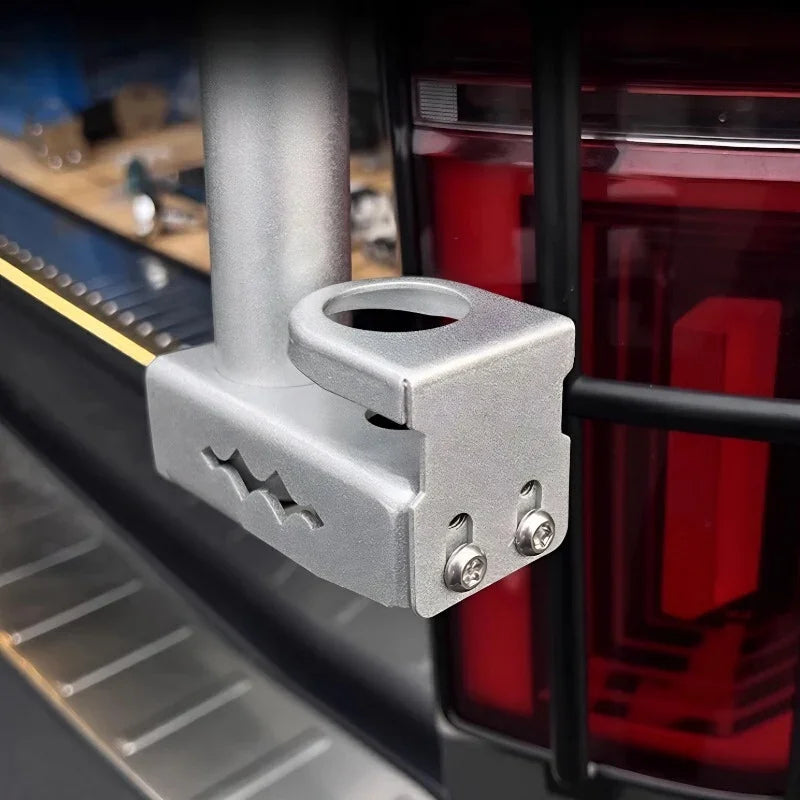 Silver anodized aluminum cup holder accessory mounted on a vehicle's rear rack.