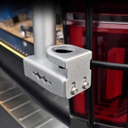 Silver anodized aluminum cup holder accessory mounted on a vehicle's rear rack.