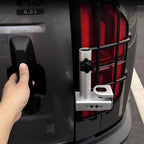 Silver aluminum bike rack mount attached to a black rear car guard with a black handle