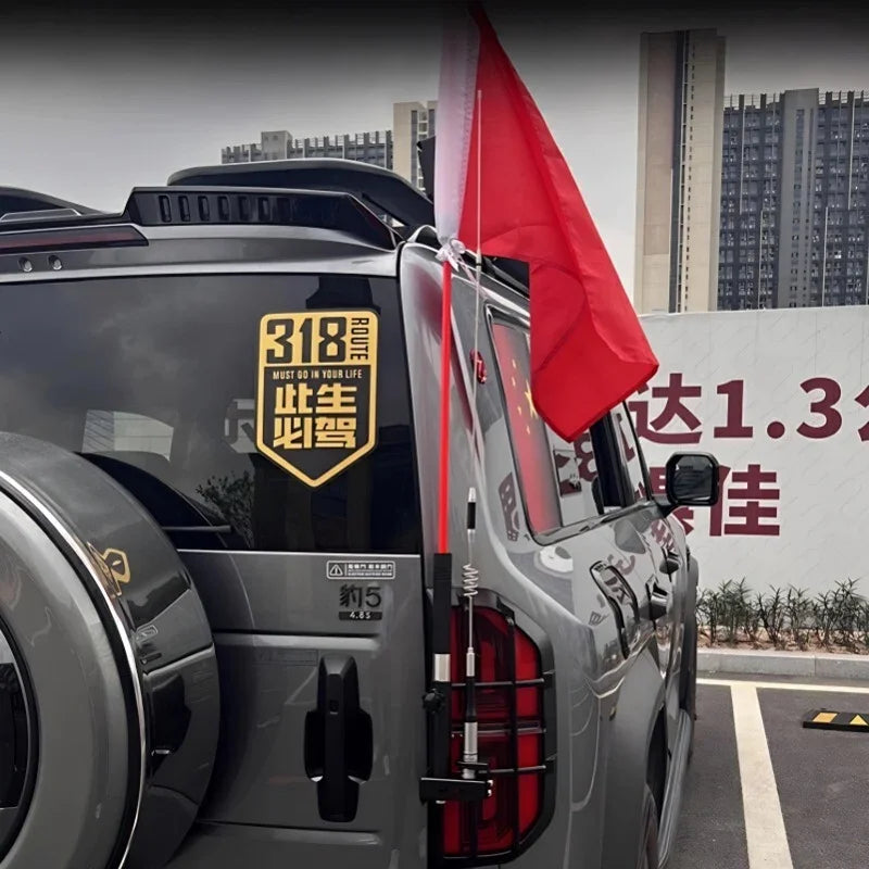 Grey off-road vehicle featuring a durable metal flag pole holder with a red flag.