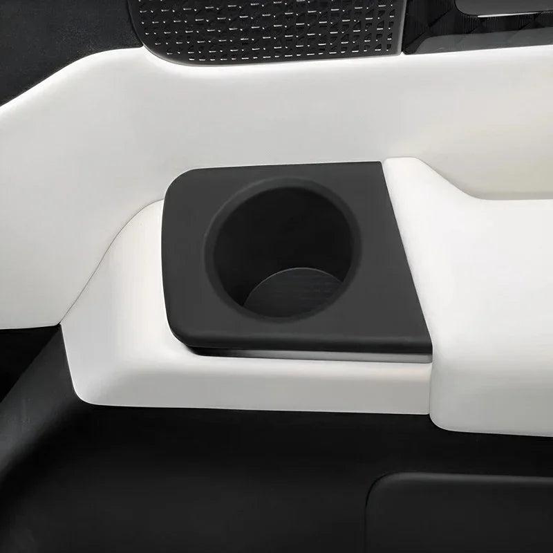 Matte black premium car interior cup holder integrated into a white console design.