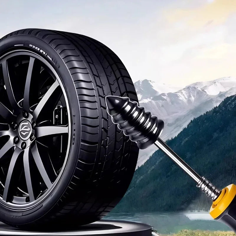 Black rubber tire plug tool being used to repair a car tire against a mountain landscape.
