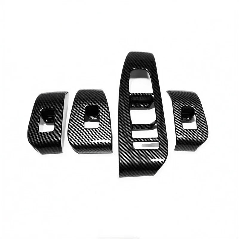 Set of four black carbon fiber interior trim accessories for BYD car dashboard enhancement.