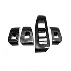 Set of four black carbon fiber interior trim accessories for BYD car dashboard enhancement.