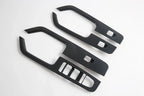 Black carbon fiber texture interior trim panels for car door handles and consoles.