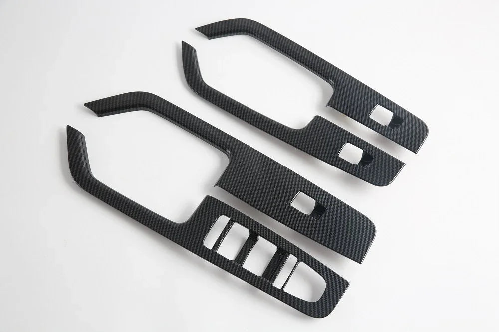 Black carbon fiber texture interior trim panels for car door handles and consoles.