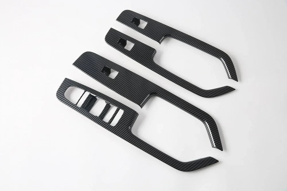 Black carbon fiber pattern interior door handle trim kits for BYD vehicles.