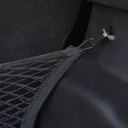 Close-up of a black mesh car storage net with a durable clip attachment.