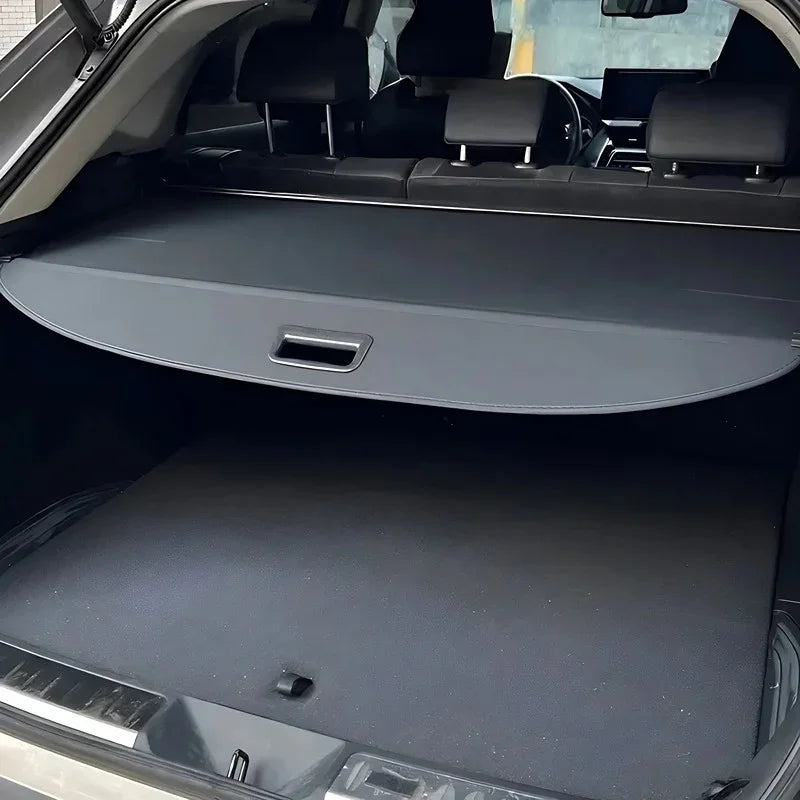 Black leather-textured retractable cargo cover for BYD trunk protection.