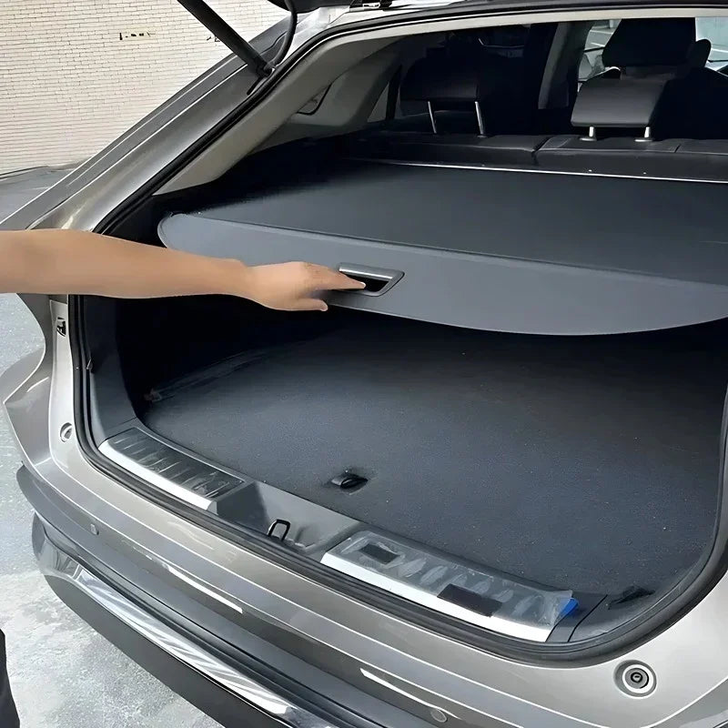 Black fabric trunk cargo cover for BYD, providing a custom fit and sleek protective finish.