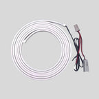 Coiled white LED strip light with red and black wiring and connectors for car interior accenting.