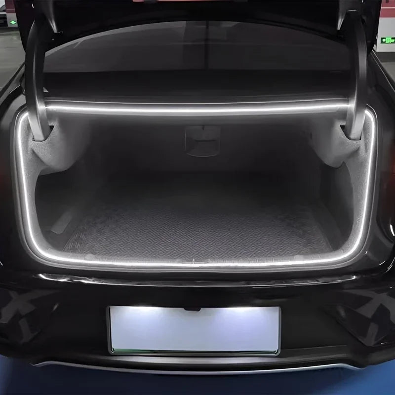 Black BYD trunk with integrated white LED strip lighting and a grey textured cargo mat.