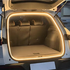 Warm white LED strip lighting installed in a car trunk for enhanced interior visibility.