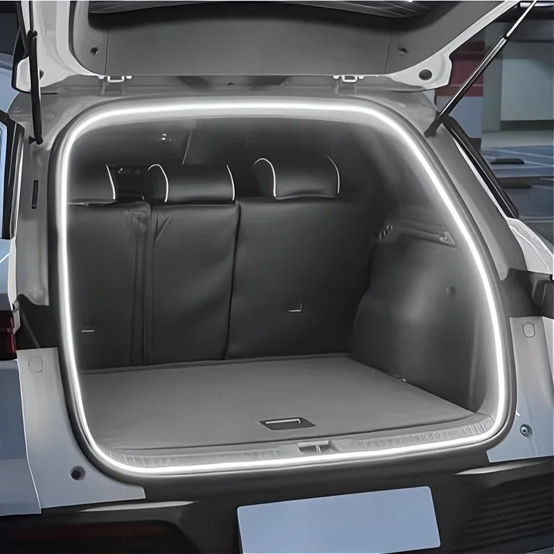 White LED strip lighting illuminating the car trunk interior with a bright, modern glow.