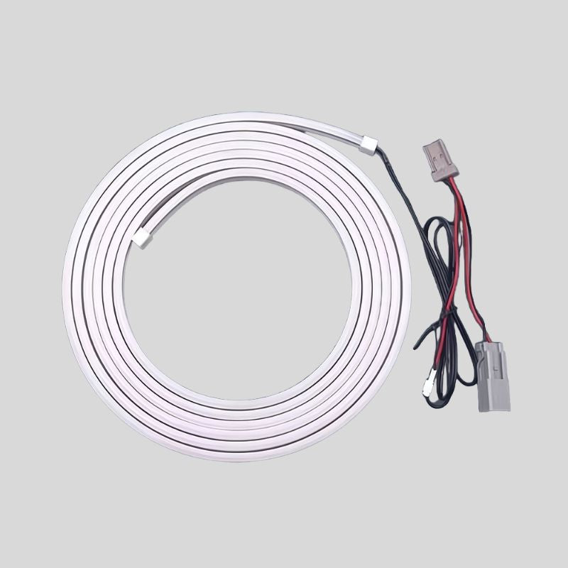 Coiled white LED strip light with black and red wiring and connectors for car customization.