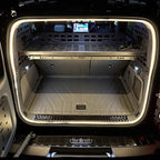 Grey durable storage organizer and cargo liner in a BYD trunk with LED lighting.
