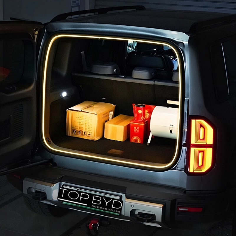BYD car trunk with yellow LED ambient lighting strips and cargo boxes