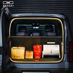 Open trunk of a grey BYD vehicle featuring warm LED ambient lighting and cargo storage.