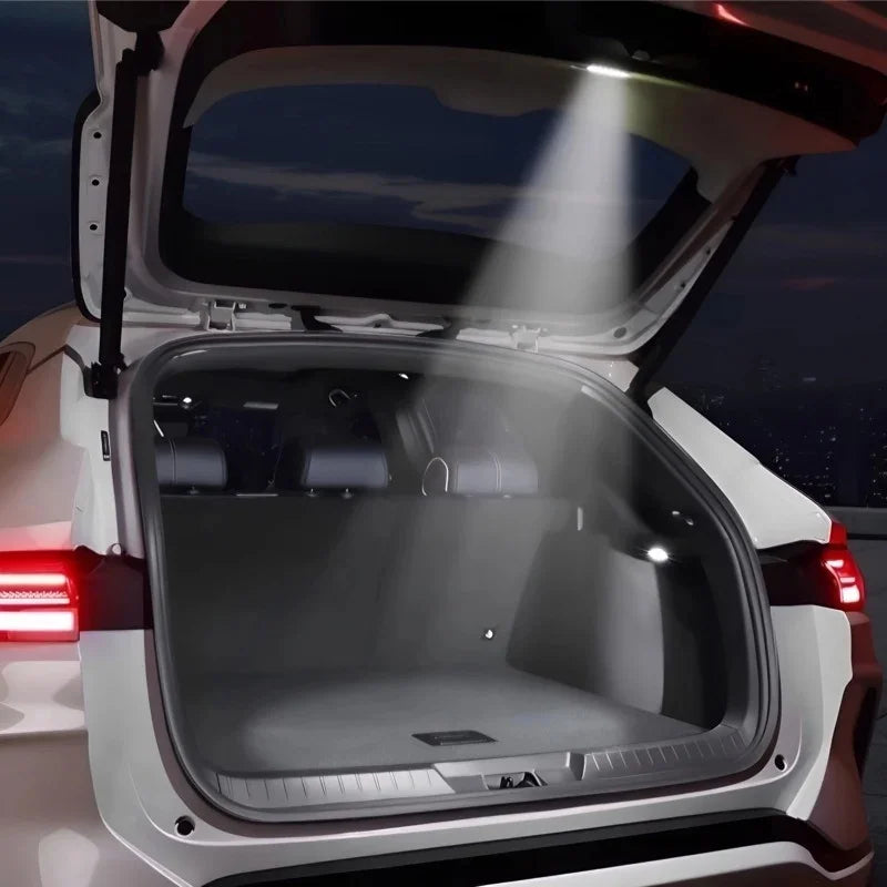 Bright white LED trunk light illuminating the interior of a white car's cargo area