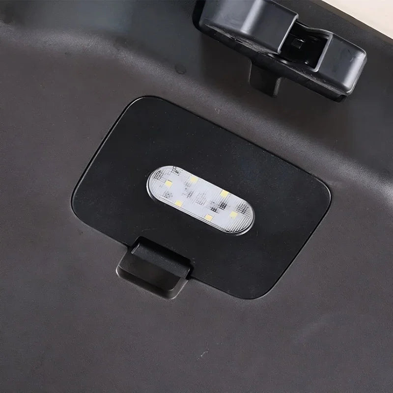 Black matte plastic car trunk organizer with an integrated LED light panel