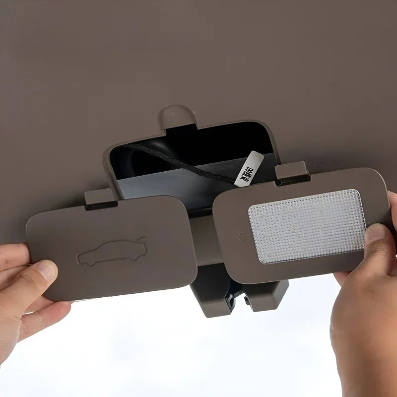 Brown leather car sun visor organizer with integrated storage compartment and white mesh pocket.