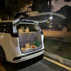 White BYD SUV with open trunk featuring tan custom-fit waterproof cargo liners and storage mats.