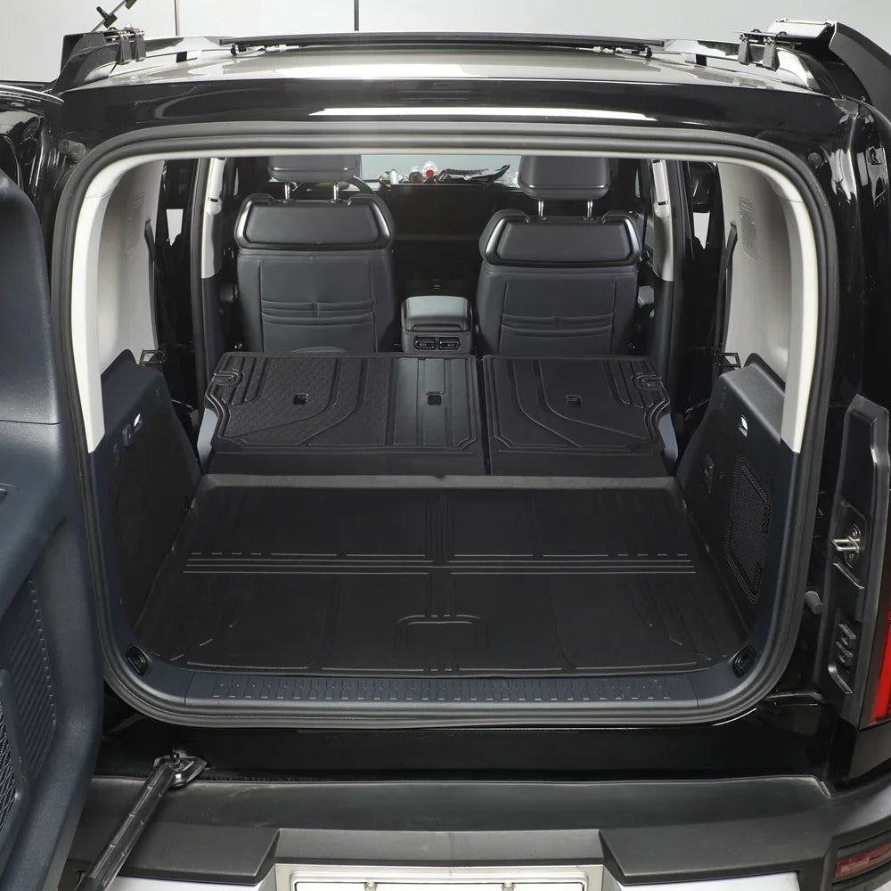 Black heavy-duty waterproof cargo mat installed in the trunk of a vehicle for spill protection.