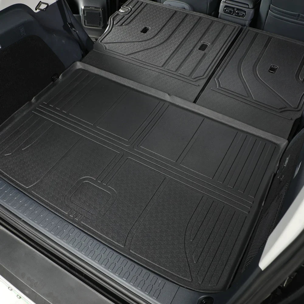 Black heavy-duty rubber cargo mat protecting the rear trunk area of a vehicle.