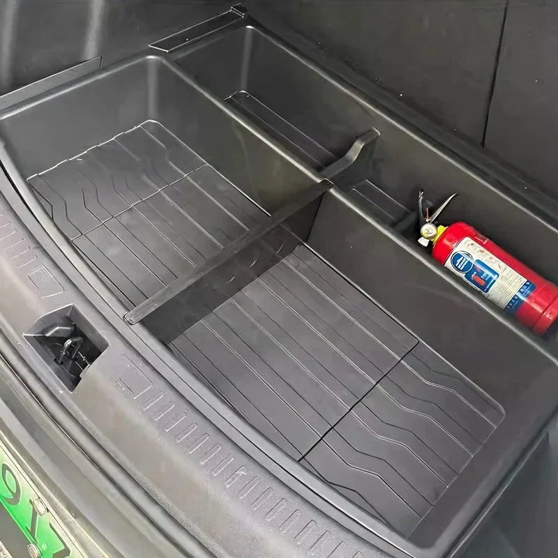 Black heavy-duty rubberized trunk organizer mat with compartments and a red fire extinguisher.