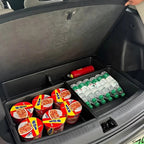 A black plastic trunk organizer in a car trunk containing instant noodle cups and water bottles.