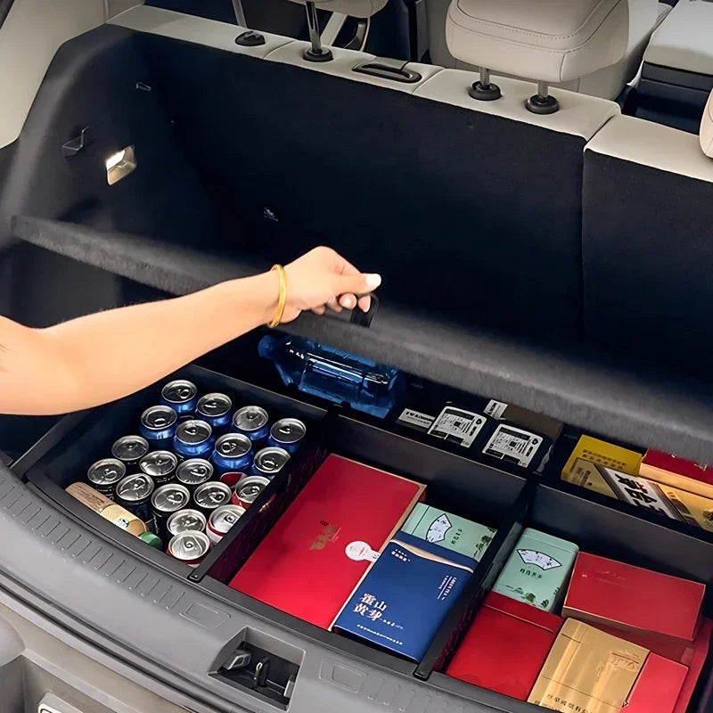 Black custom-fit trunk organizer box containing canned drinks and various packaged goods.