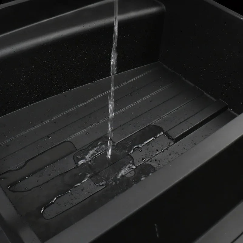 Water pouring into a durable black waterproof car trunk liner tray.