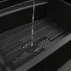 Water pouring into a durable black waterproof car trunk liner tray.