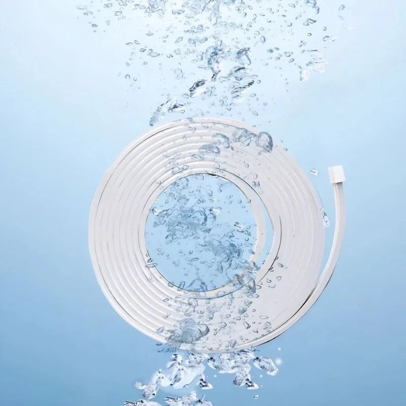 White waterproof LED strip light coiled and submerged in splashing clear water.
