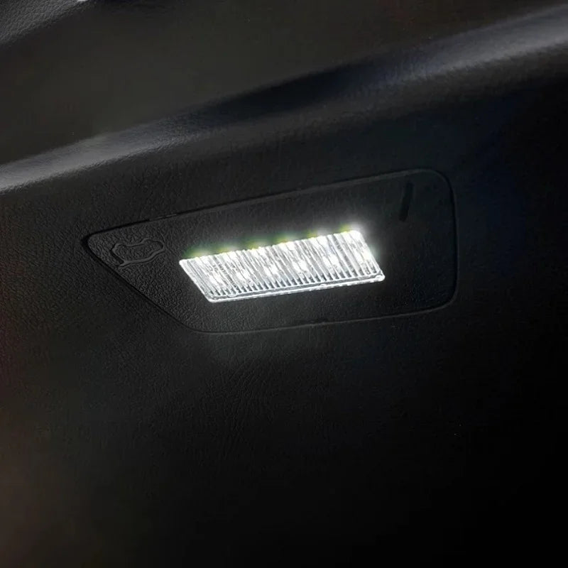 Bright white LED interior dome light installed on a black car ceiling trim.