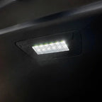 Bright white LED interior dome light installed on a black car ceiling trim.