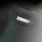 Black textured interior trim featuring a built-in rectangular LED light strip.