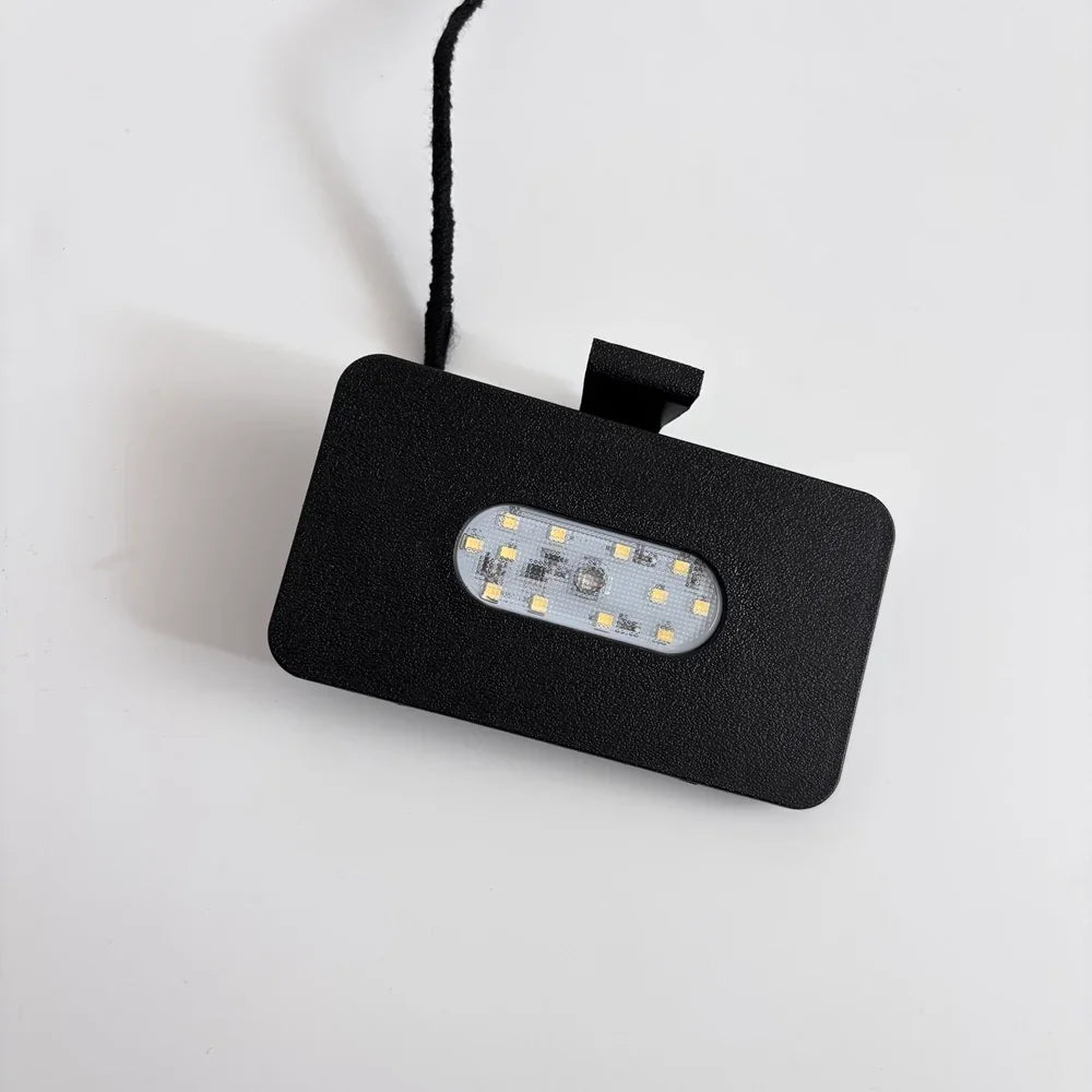 Black rectangular LED light fixture with a textured finish and integrated power cord.